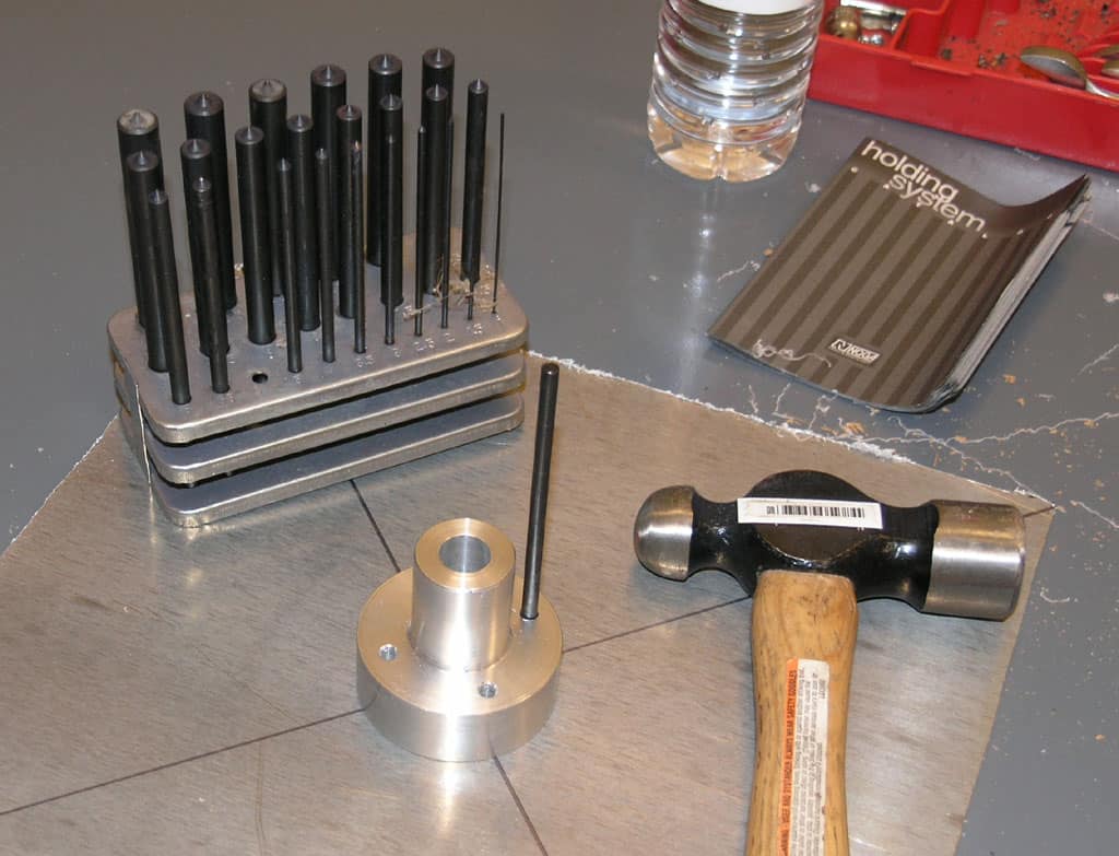 Workbench with various tools and equipment arranged on a wooden table or bench.