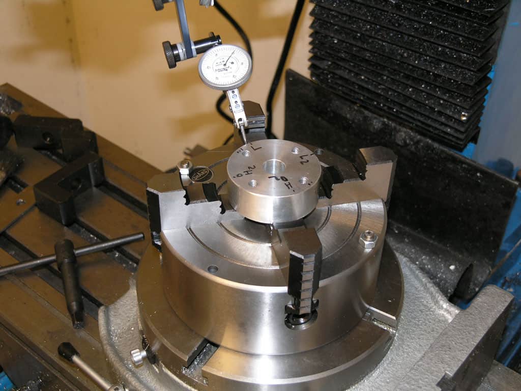 Precision measuring instrument with dial gauge on metal surface.