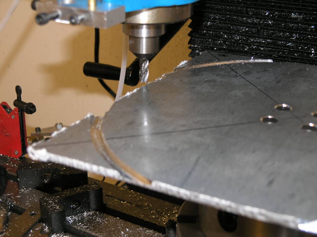 CNC milling machine in operation, cutting through metal.