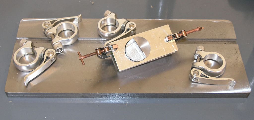 Metal tool with silver details on a gray background, dual-angle views.