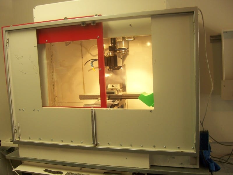 A large white machine with a red accent and windowed front.