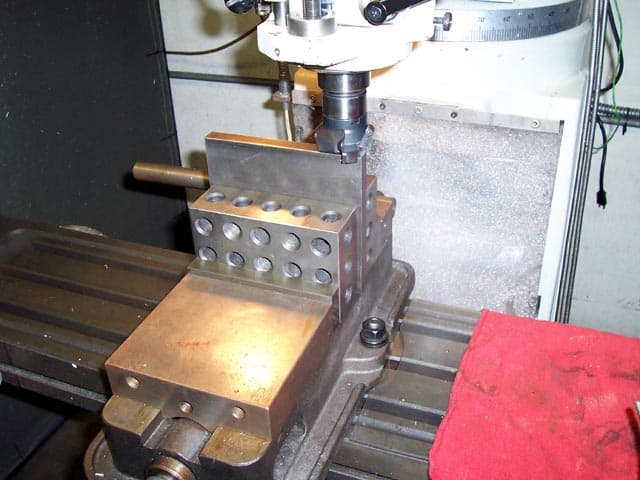Metalworking machine tool, plate squaring device with rectangular base and holes/slots.