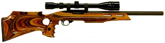 A rifle with a wooden stock and long barrel on a light gray background.