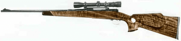 Wooden-stock rifle with sleek black scope on white background.