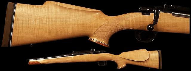 Wooden-stock rifle with long barrel and scope.