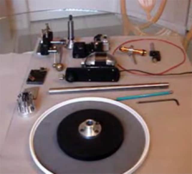 Metal fabrication tools and machinery parts on a table.