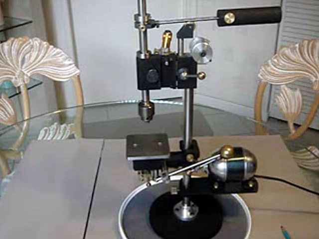 Turntable with glass top and wooden handles.