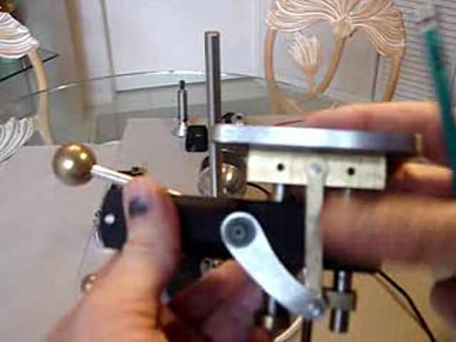 Hand grasping metal precision tool with ball-ended rod.
