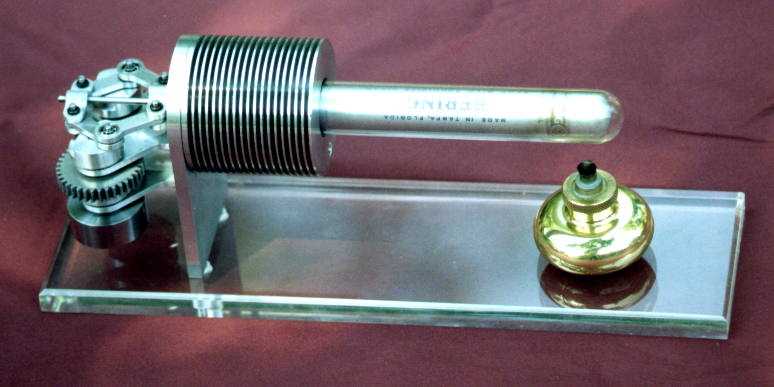 Silver metal gear system on glass base.