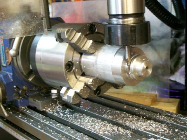 Metalworking lathe with visible tooling marks and debris.