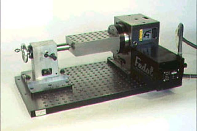 Specialized tooling fixture with 4 axes of motion for machining complex geometries.