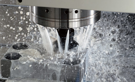 Metal part with circular ring and coolant droplets.