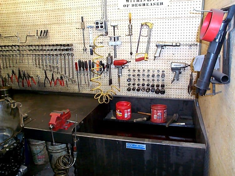 Well-organized workshop with metal sink and various tools.