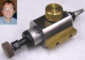 Close-up of a die grinder with gold knob and extension rod.