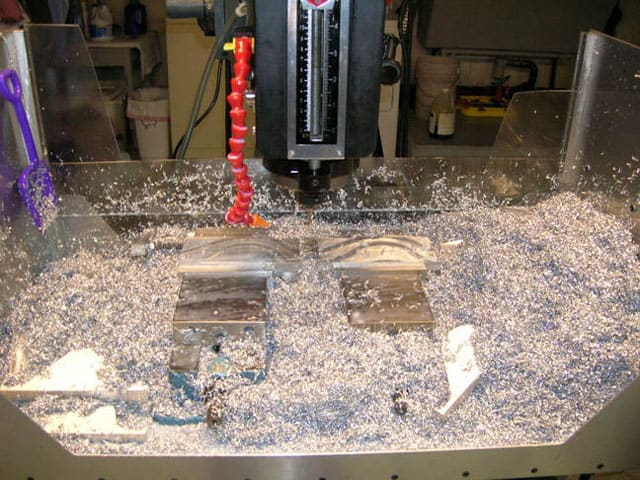 Industrial machine surrounded by debris and tools.