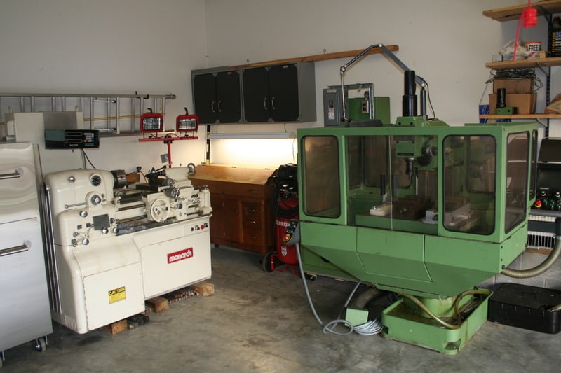 Well-organized garage workshop with lathe and milling machine.