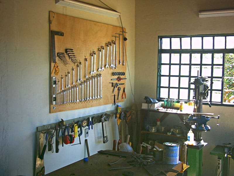 Well-organized workshop with woodworking tools and metalworking machinery.