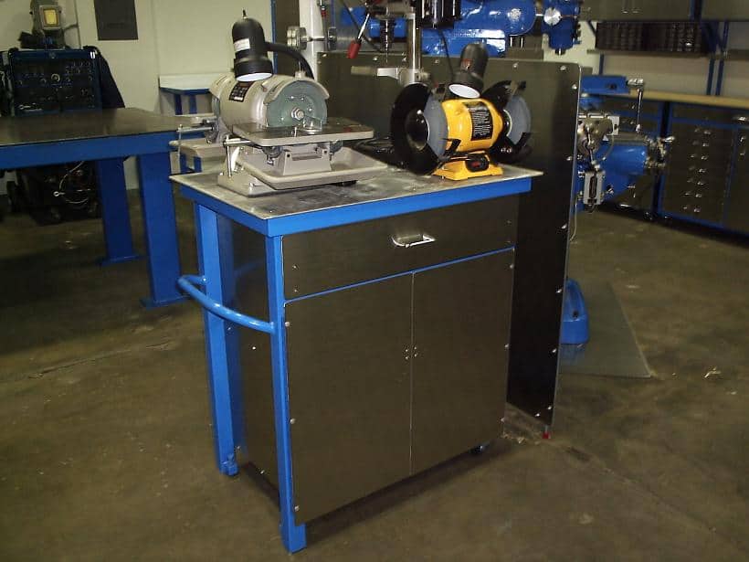 A blue-painted metal workshop cart with multiple grinders and tools.