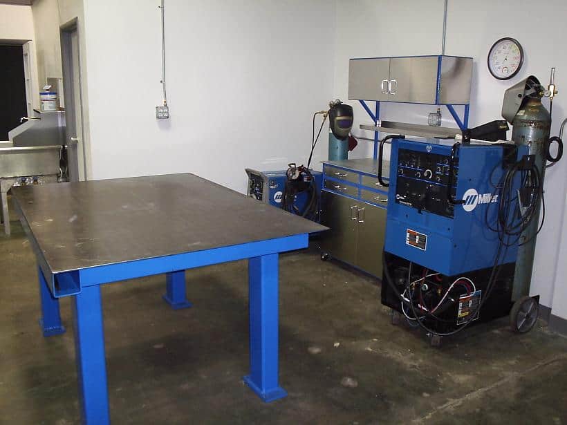 Well-equipped welding area in a workshop or factory setting.