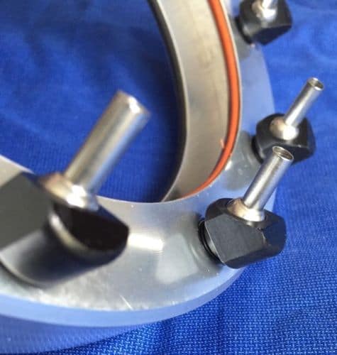 Silver cylindrical nozzle with black handle on a blue background.