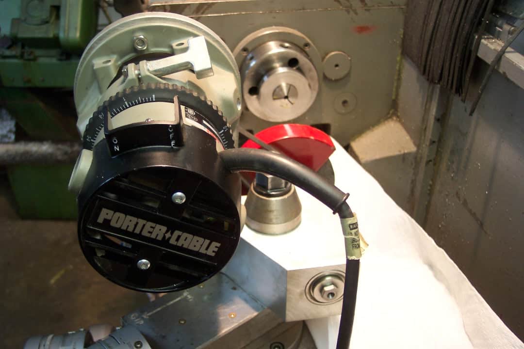 A Porter-Cable woodworking router with black and silver body, prominent logo, circular base, and cord.