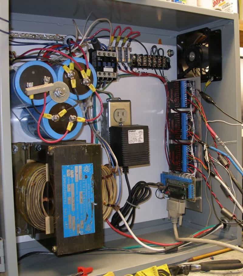 Metal power supply unit with complex wiring and circuit boards.