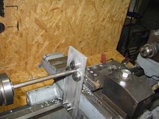 Metal lathe mounted in front of an OSB wall panel.
