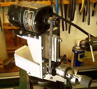 A black and silver bench grinder in a workshop setting.