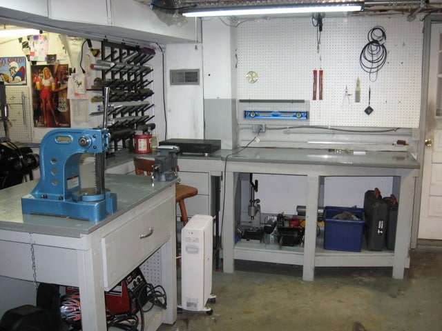 Well-organized workshop with drill press, machinery, and storage units.