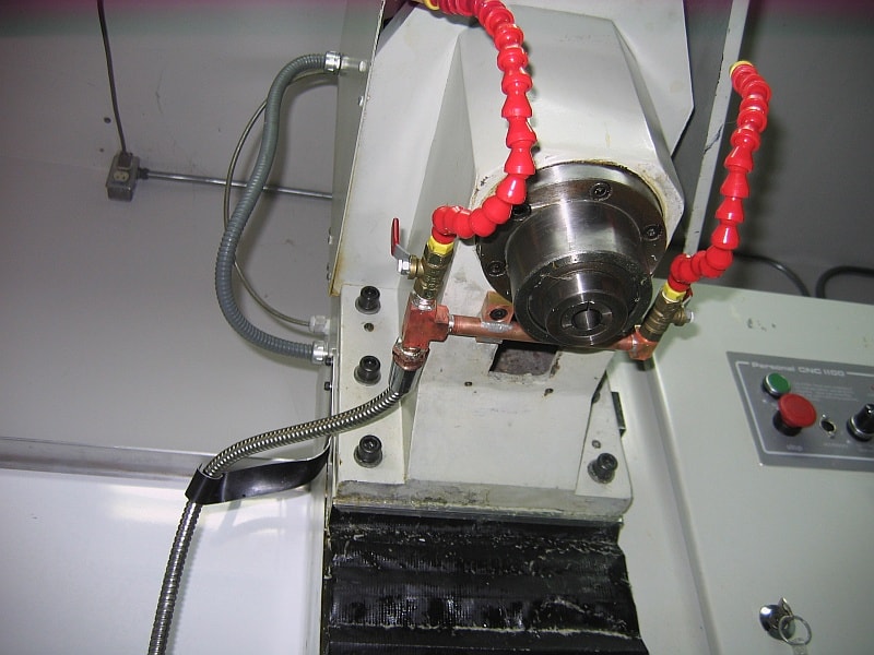 White machine with red tubing and black manifold.