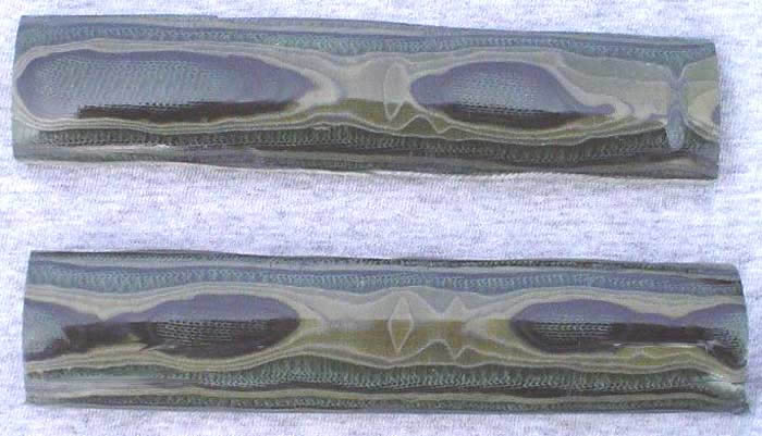 Dark-colored metallic or stone objects with wavy edges arranged in a staggered formation.