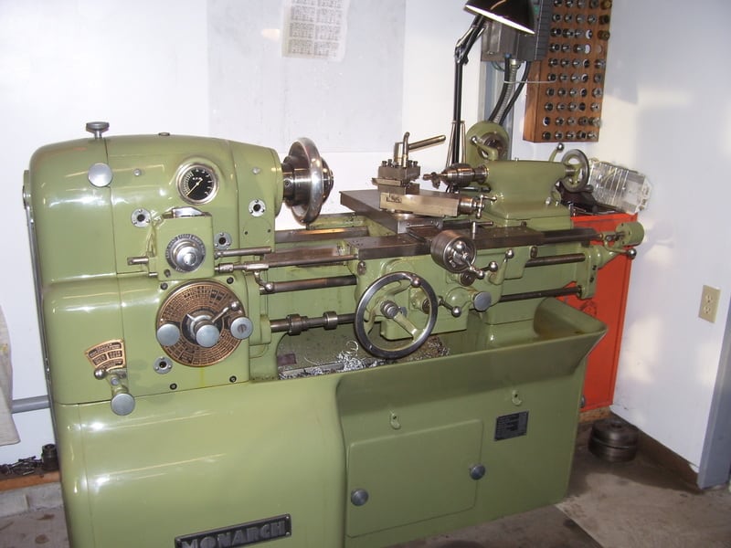 Industrial metalworking lathe in workshop setting, labeled "MONARCH".