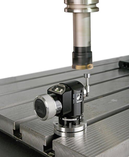 A tool setter device for CNC machining centers, featuring a cylindrical metal component with a black base and silver top, mounted on a metal table.