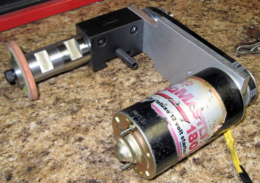 Metal tool on speckled brown countertop with silver components and white label reading "180".