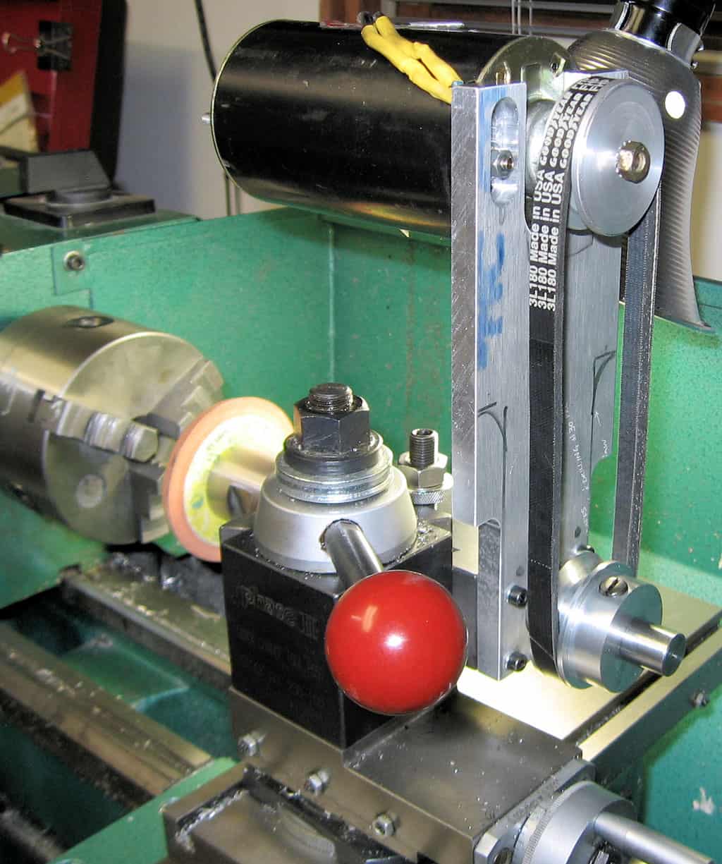 Industrial lathe in workshop setup.