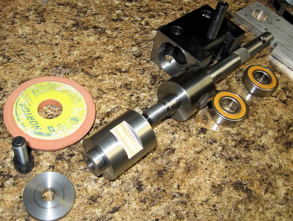 Metalworking tools and parts on granite countertop.