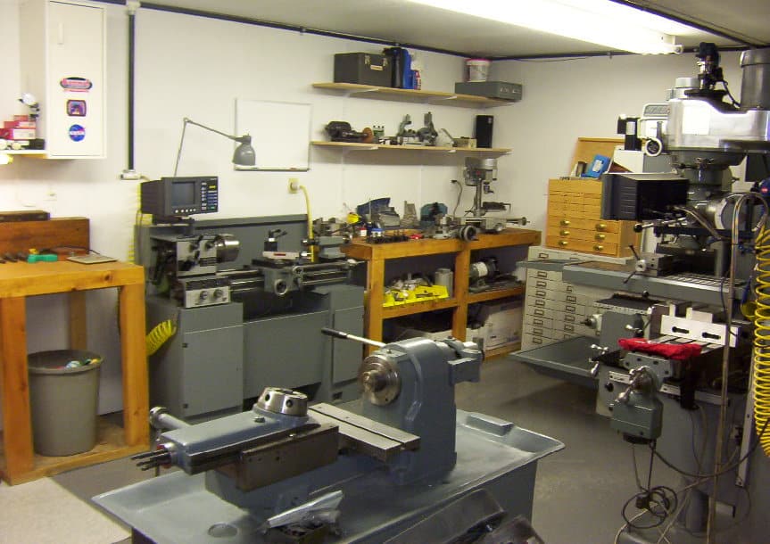 Well-organized metal fabrication workshop with lathes, mills, and grinders.