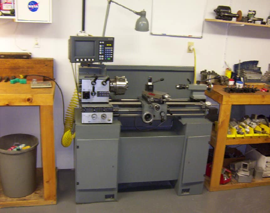 Well-equipped workshop with lathe machine and tools.