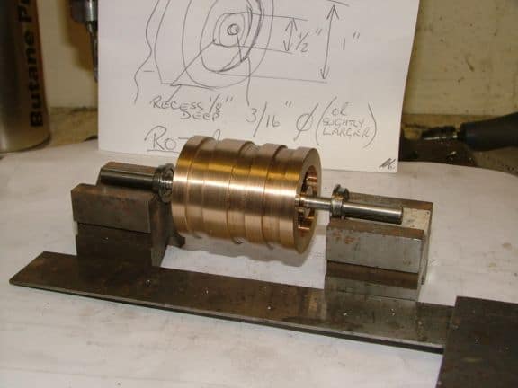 Metal shaft with cylindrical component on metal base.