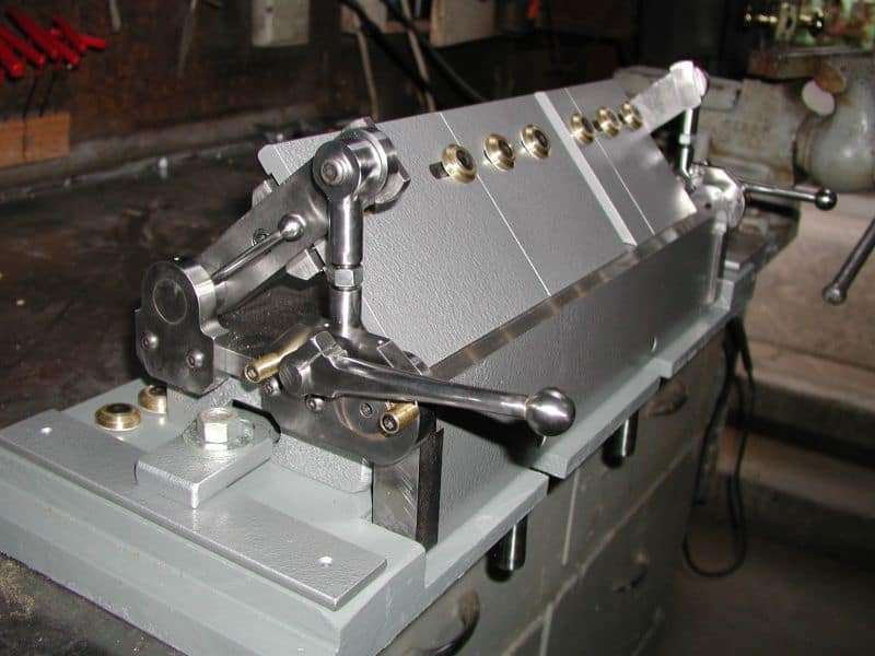 Box brake machine with rollers and handle.