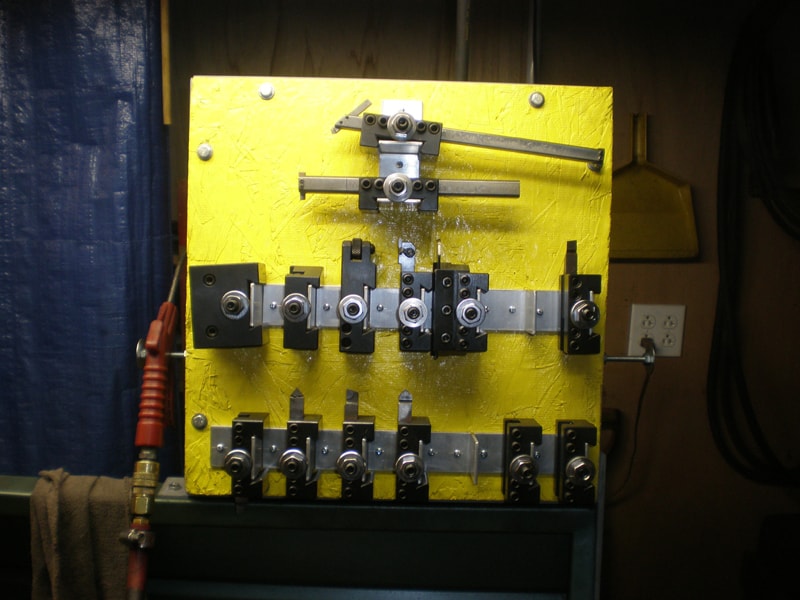 Yellow metalworking machine with attached tools.