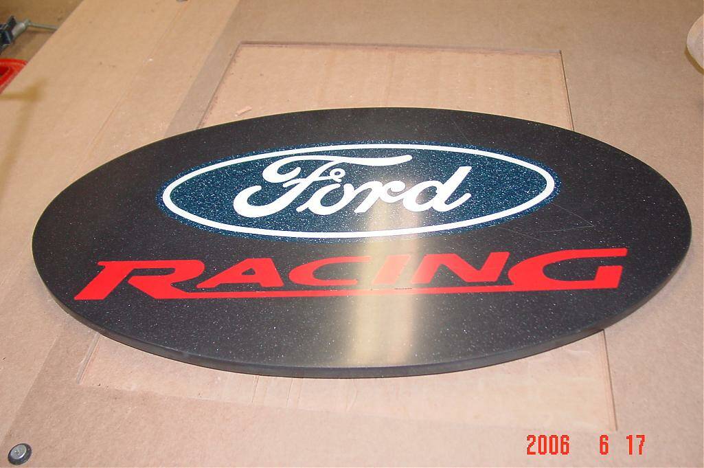 Ford Racing Oval Sign with Blue Outline on Black Background.
