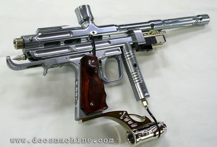 Silver paintball gun with dark wood grip handle on a white background.