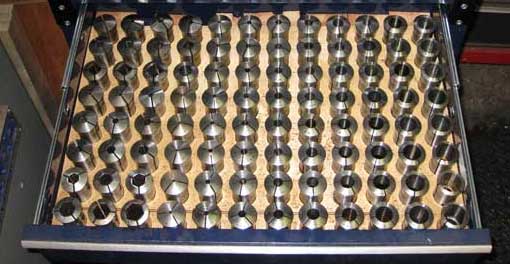Metal tools in a drawer on a dark background.