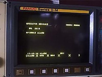 Fanuc Spindle Alarm screen displaying critical operator message and red "FANUC Series O-M" banner.