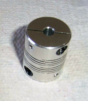 Machined metal part with helical groove pattern.