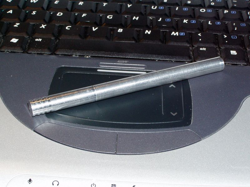 Aluminum pen on laptop touchpad.