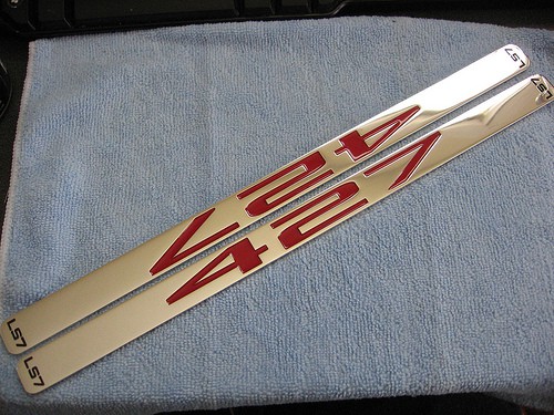 Gold metal piece with red text CNCCookbook.com branding logo