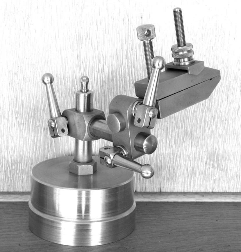 Metal vise with adjustable jaws and rotating base.
