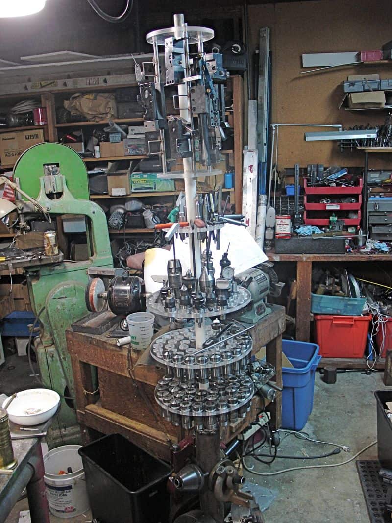 A cluttered workshop with a lathe, mill, and other machinery.